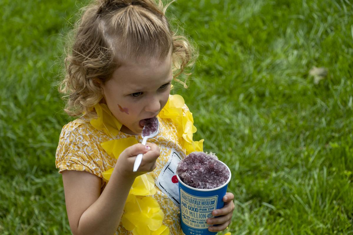 Girl eating a snow cone at East Campus Discovery Days and Farmer's Market.